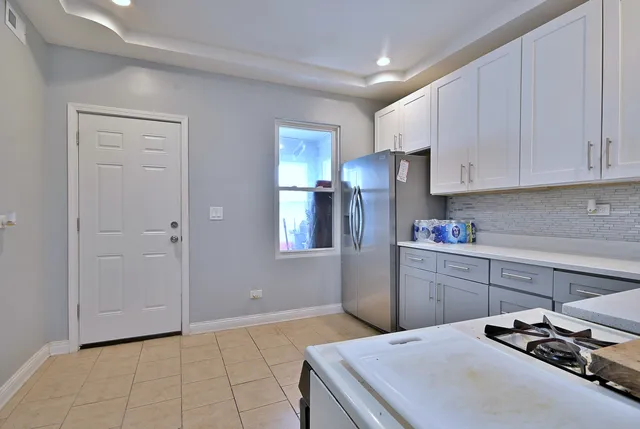 a view of a kitchen with wooden floor and electronic appliances