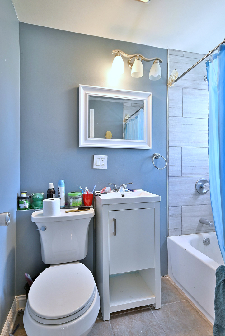 5125 South Elizabeth Street Chicago, IL 60609 - Photo 38 of 61 a white toilet sitting next to a bathroom sink