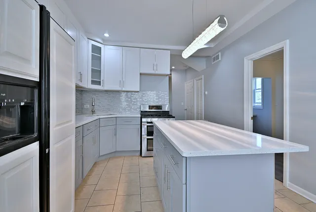 a bedroom with a bed and a night stand