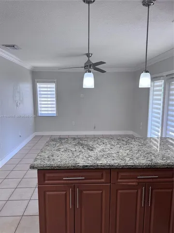 a view of a kitchen island cabinets and window