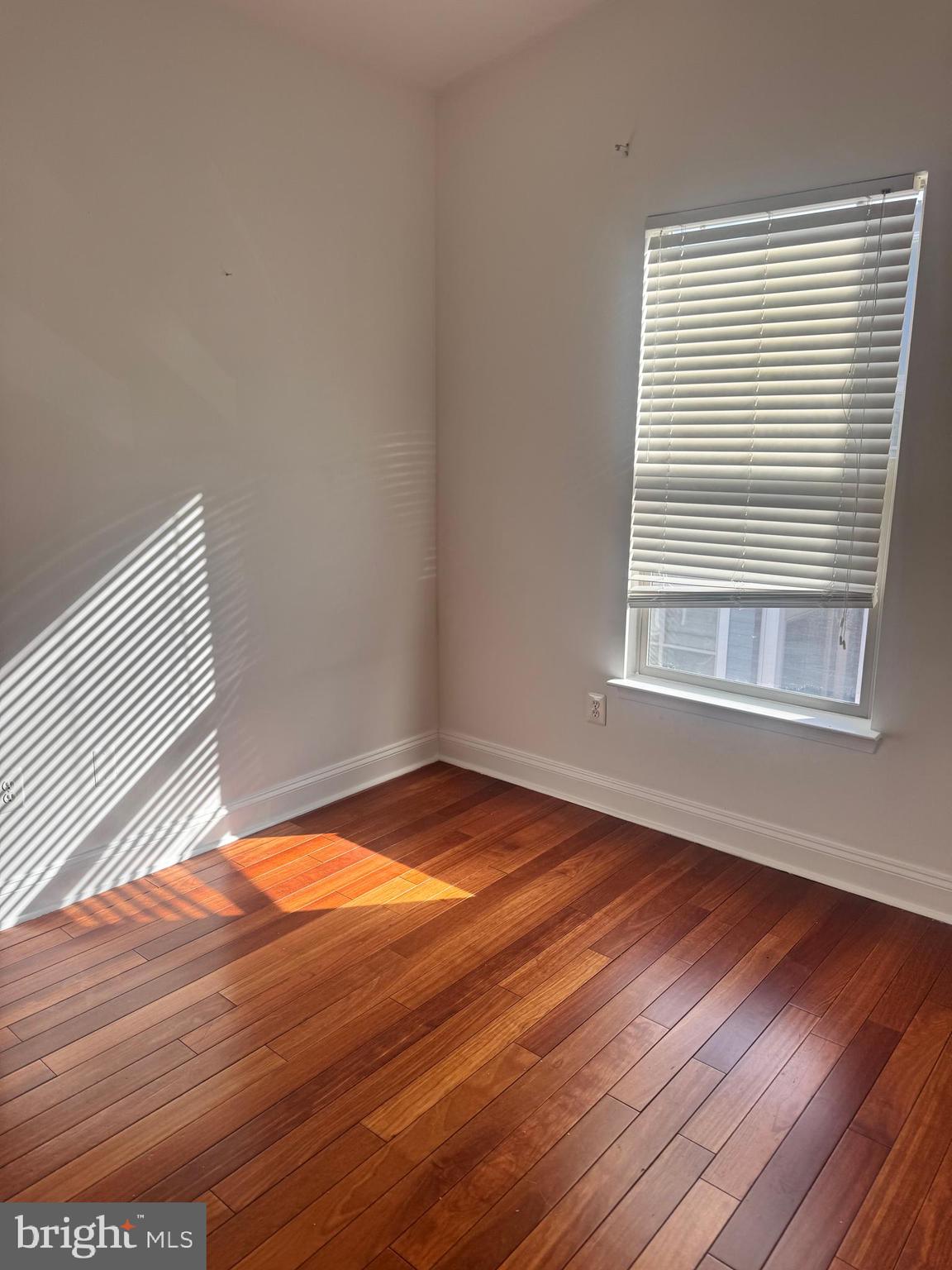 127 Albemarle Street, Unit 36 Baltimore, MD 21202 - Photo 19 of 25 a view of empty room with wooden floor and fan