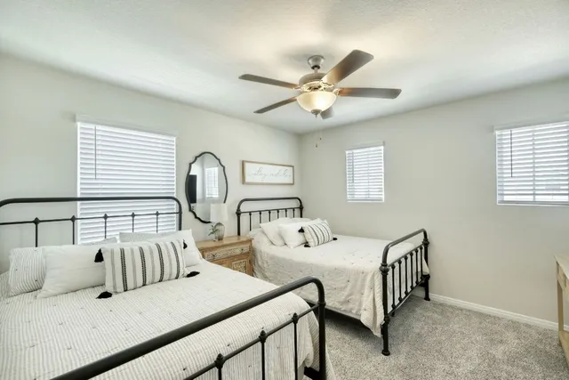 a bedroom with a bed and a ceiling fan
