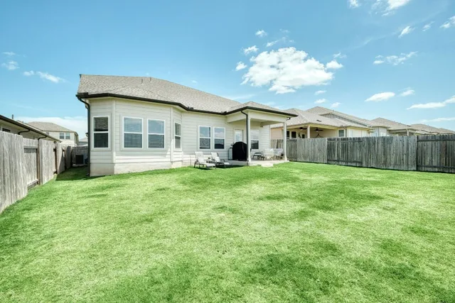 a view of a house with backyard porch and garden