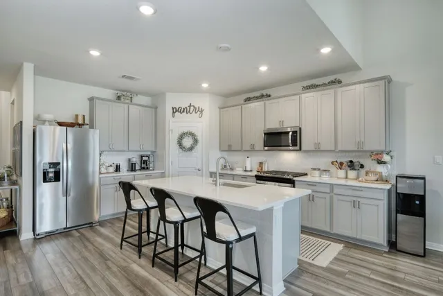 a view of kitchen with cabinets table and chairs