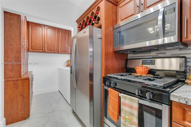 a kitchen with stainless steel appliances granite countertop a stove and a refrigerator