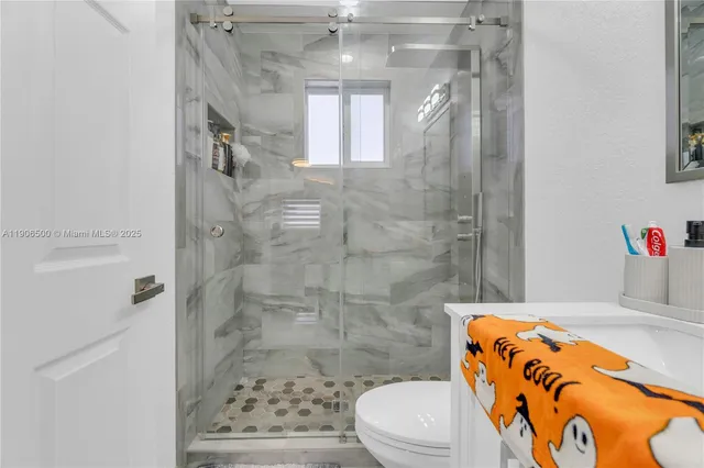 a bathroom with a sink toilet and shower