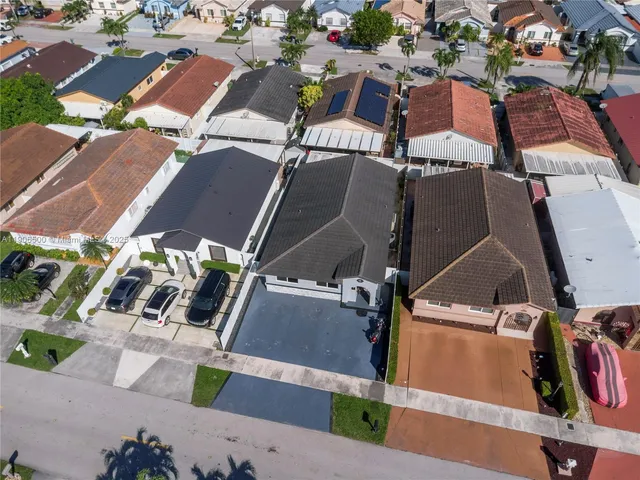 an aerial view of a house with a yard