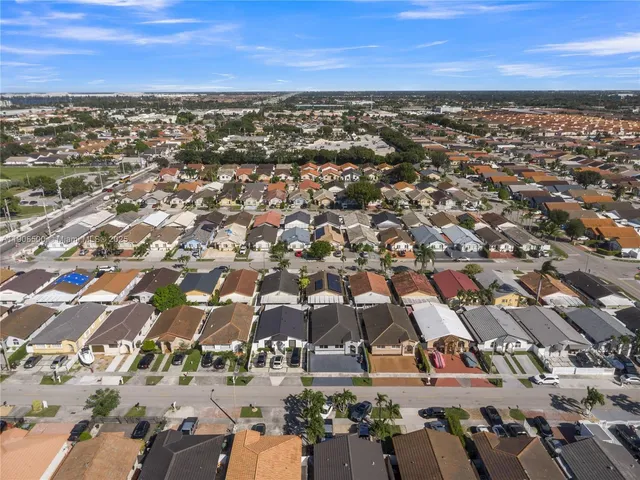 an aerial view of residential houses with outdoor space