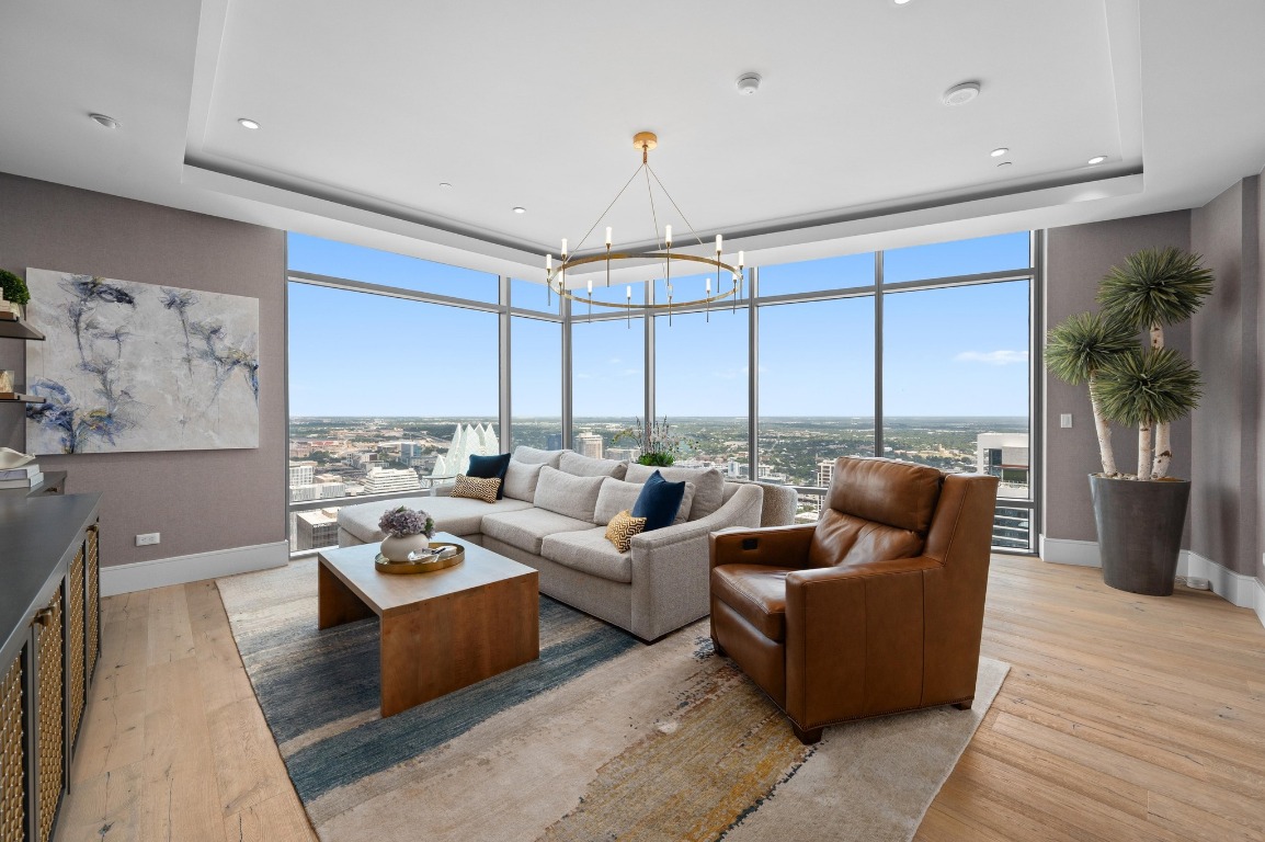 a living room with furniture potted plant and a large window