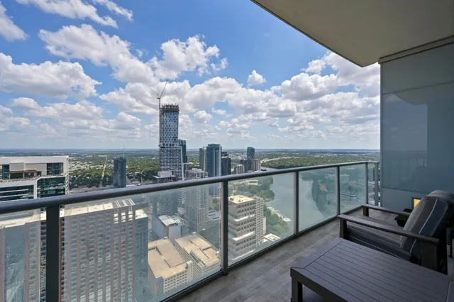 a view of a balcony with two chairs