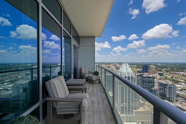 a view of a balcony with chairs