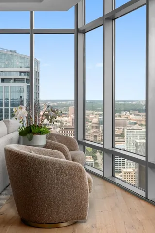 a living room with furniture and floor to ceiling windows