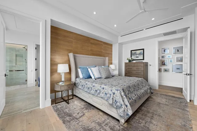 a bedroom with a large bed and a chandelier