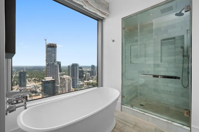 a bathroom with a bathtub and shower