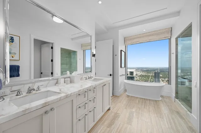 a spacious bathroom with a double vanity sink and a large mirror