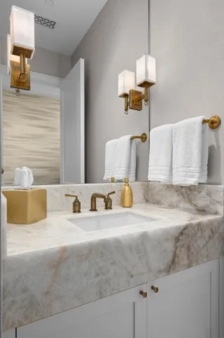a bathroom with a granite countertop sink and a mirror
