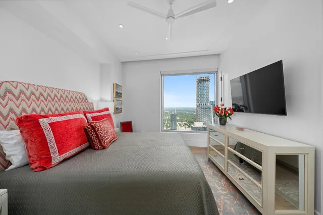 a bedroom with a bed and a flat screen tv
