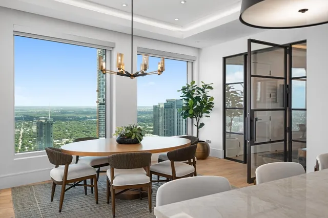 a dining room with furniture a chandelier and window