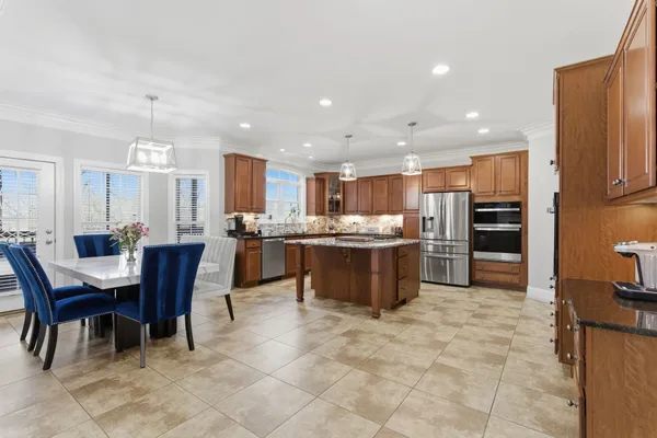 a kitchen with stainless steel appliances granite countertop a refrigerator and a sink