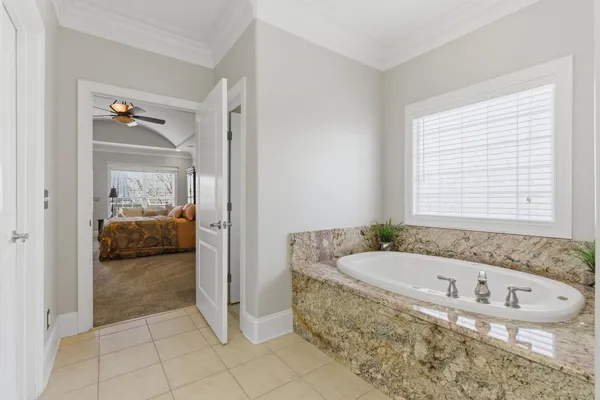 a bedroom with a bed and a flat tv screen on dresser