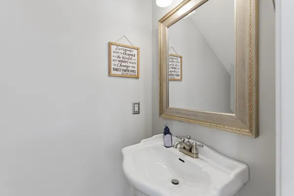 a bathroom with a granite countertop sink toilet mirror and a shower
