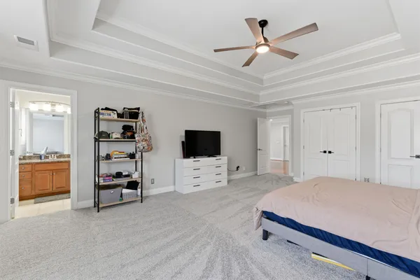 a bedroom with furniture and a flat screen tv