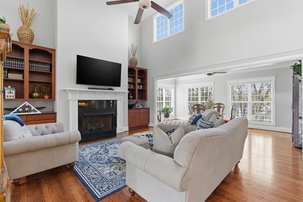 a living room with furniture a flat screen tv and a fireplace