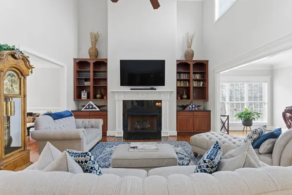 a living room with furniture a flat screen tv and a fireplace