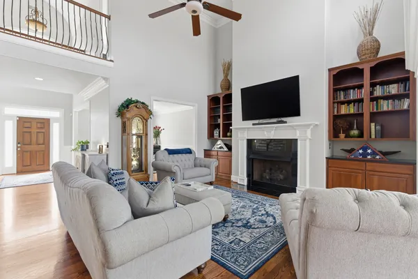 a living room with fireplace furniture and a flat screen tv