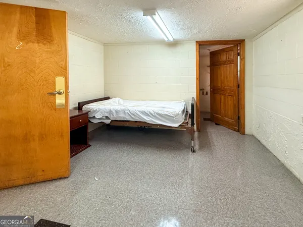 a bed sitting in a room next to a window