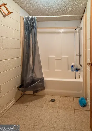 a bathroom with a toilet sink a mirror and bathtub