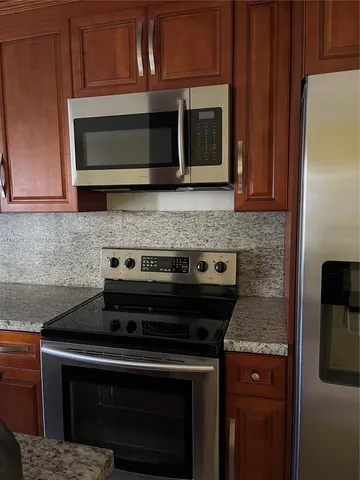 a stove top oven sitting inside of a kitchen