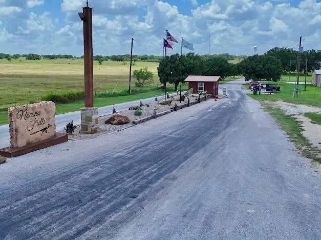 an aerial view of a house with a yard and lake view