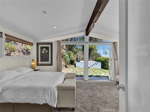 a spacious bedroom with a bed and a couch