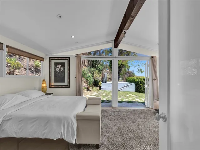 a spacious bedroom with a bed and a couch