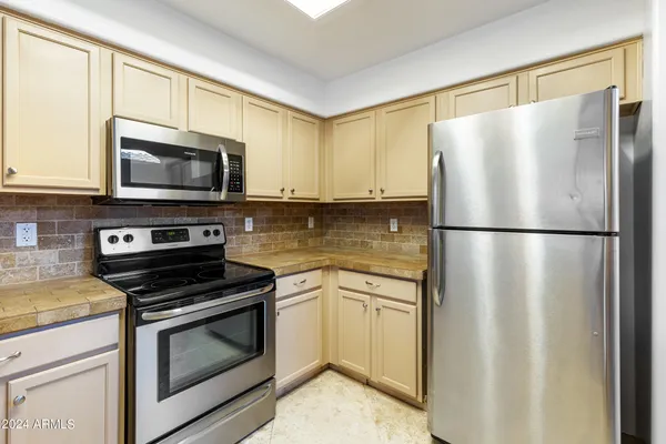 a kitchen with a refrigerator stove and microwave