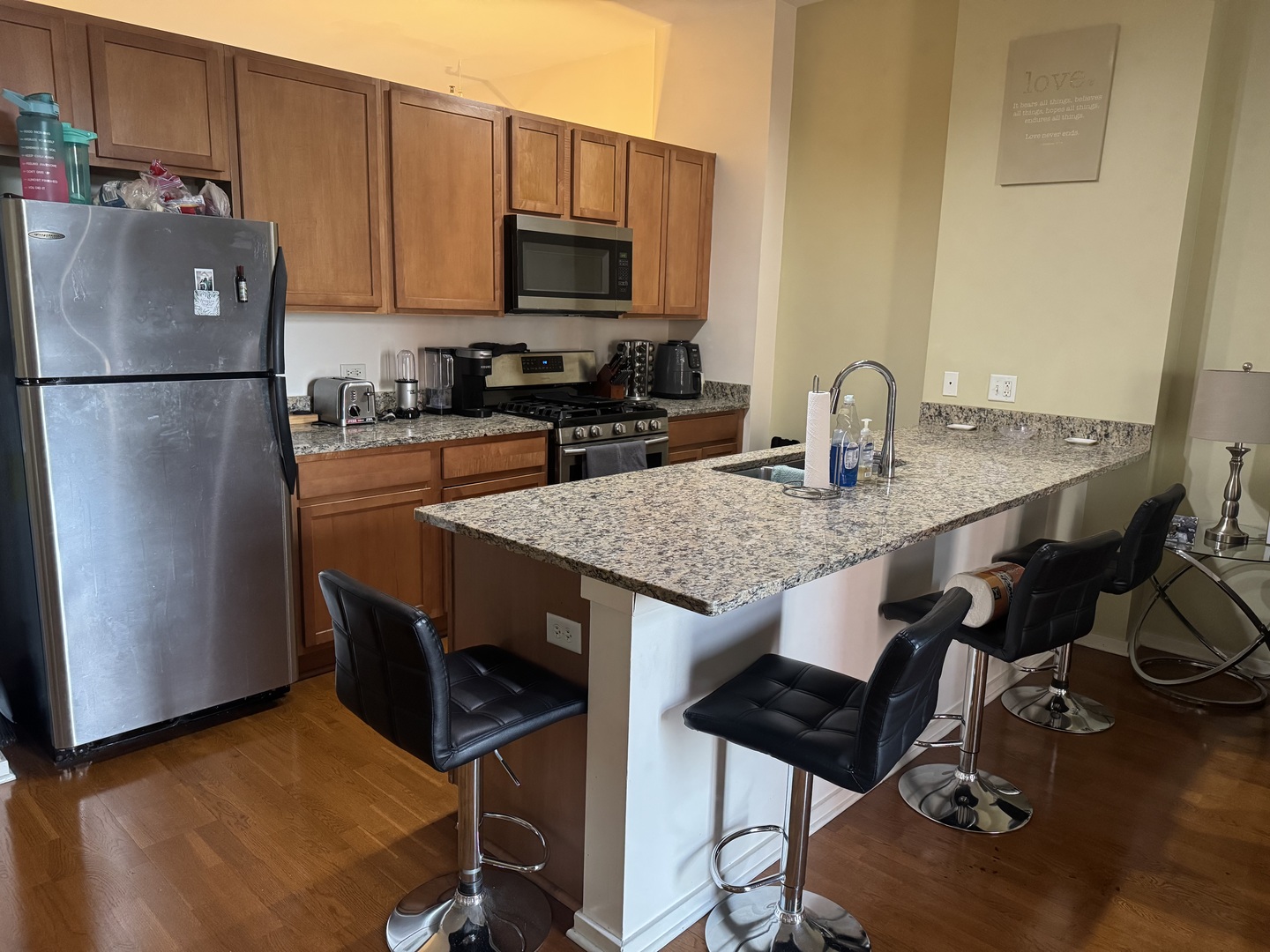 2323 West Pershing Road, Unit 417 Chicago, IL 60609 - Photo 3 of 8 a kitchen with stainless steel appliances granite countertop a sink refrigerator and microwave
