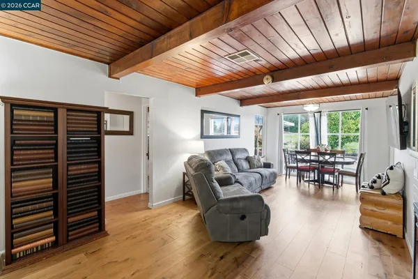 a living room with furniture and wooden floor