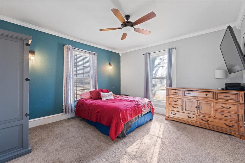 700 Euclid Street Cleburne, TX 76033 - Photo 12 of 35 a bed room with a bed and a dresser
