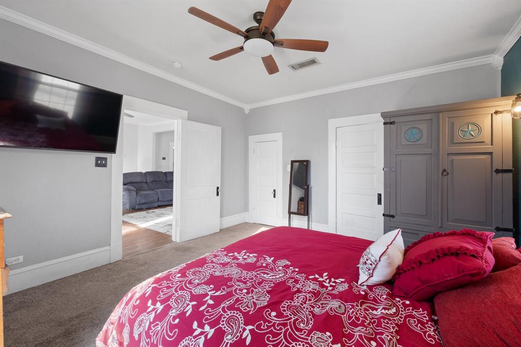 700 Euclid Street Cleburne, TX 76033 - Photo 13 of 35 a bedroom with a bed and a flat screen tv