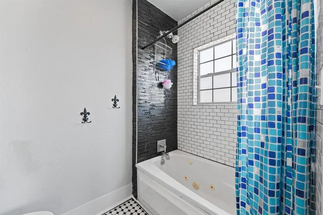 a bathroom with a bathtub and shower