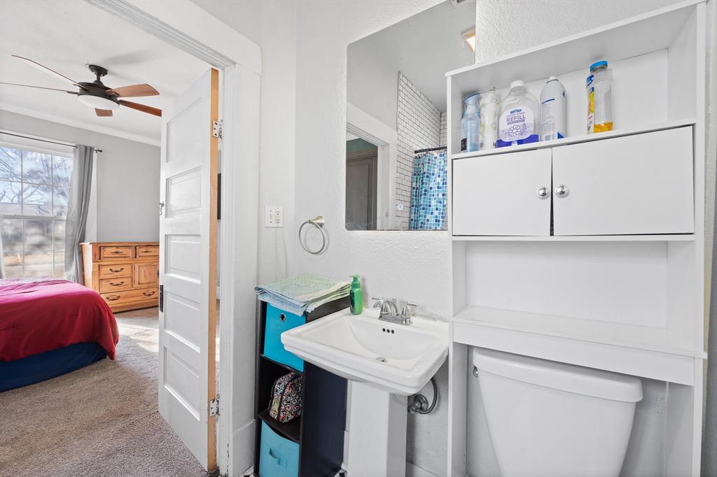 700 Euclid Street Cleburne, TX 76033 - Photo 15 of 35 a bathroom with a sink a vanity and a shower