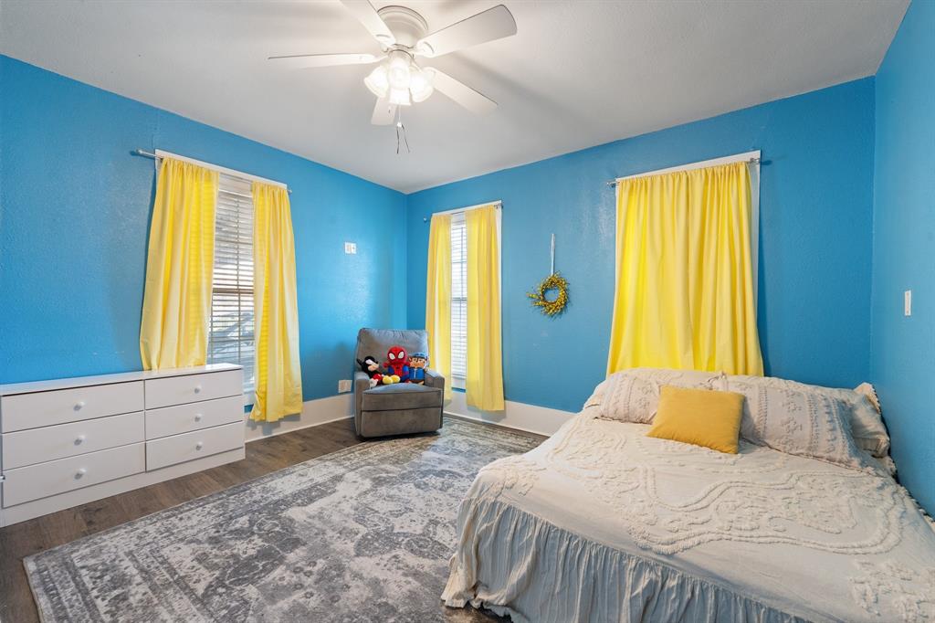 700 Euclid Street Cleburne, TX 76033 - Photo 16 of 35 a bedroom with a bed and a chandelier