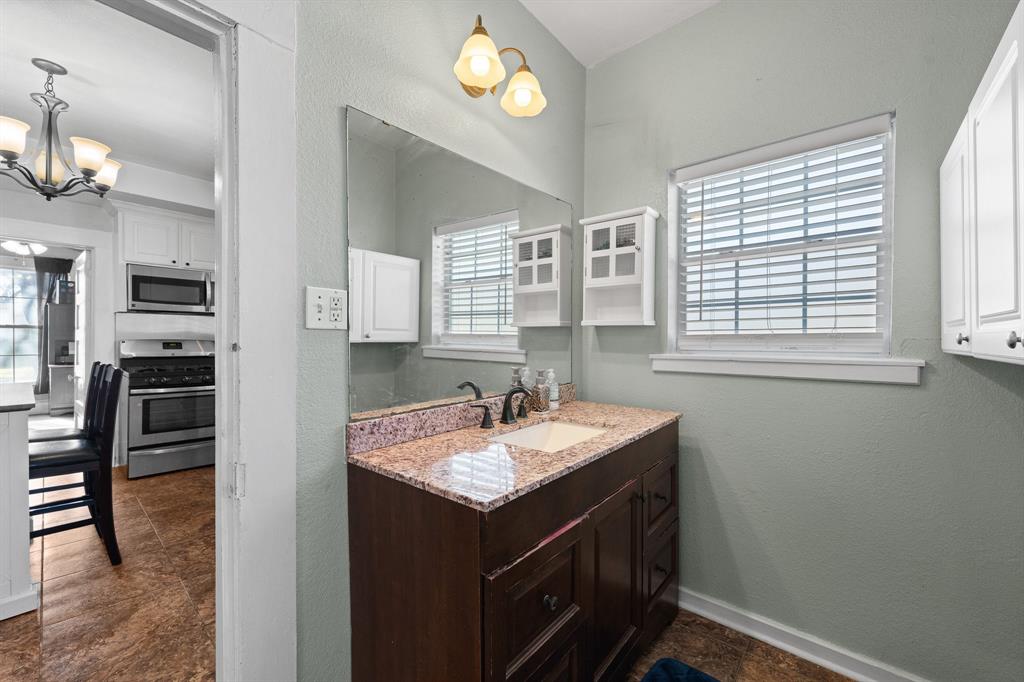 700 Euclid Street Cleburne, TX 76033 - Photo 17 of 35 a bathroom with a sink double vanity and a shower
