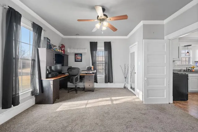 a view of a kitchen with fridge and workspace