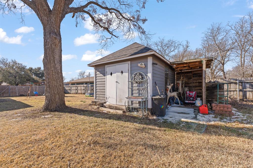 700 Euclid Street Cleburne, TX 76033 - Photo 29 of 35 a view of a house with a backyard and tree