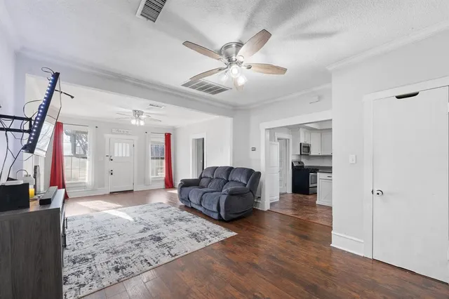 a living room with furniture and wooden floor