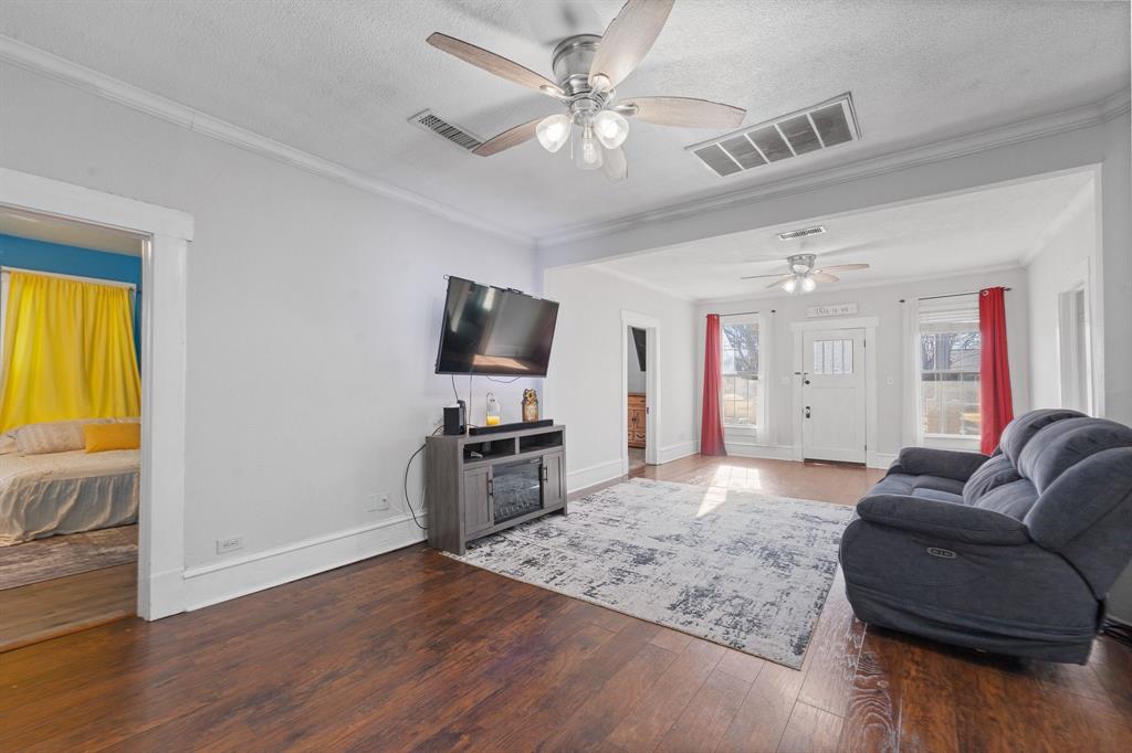 700 Euclid Street Cleburne, TX 76033 - Photo 8 of 35 a living room with furniture and a flat screen tv