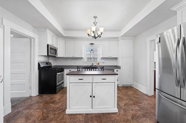 a kitchen with stainless steel appliances granite countertop a stove a refrigerator and a granite counter tops