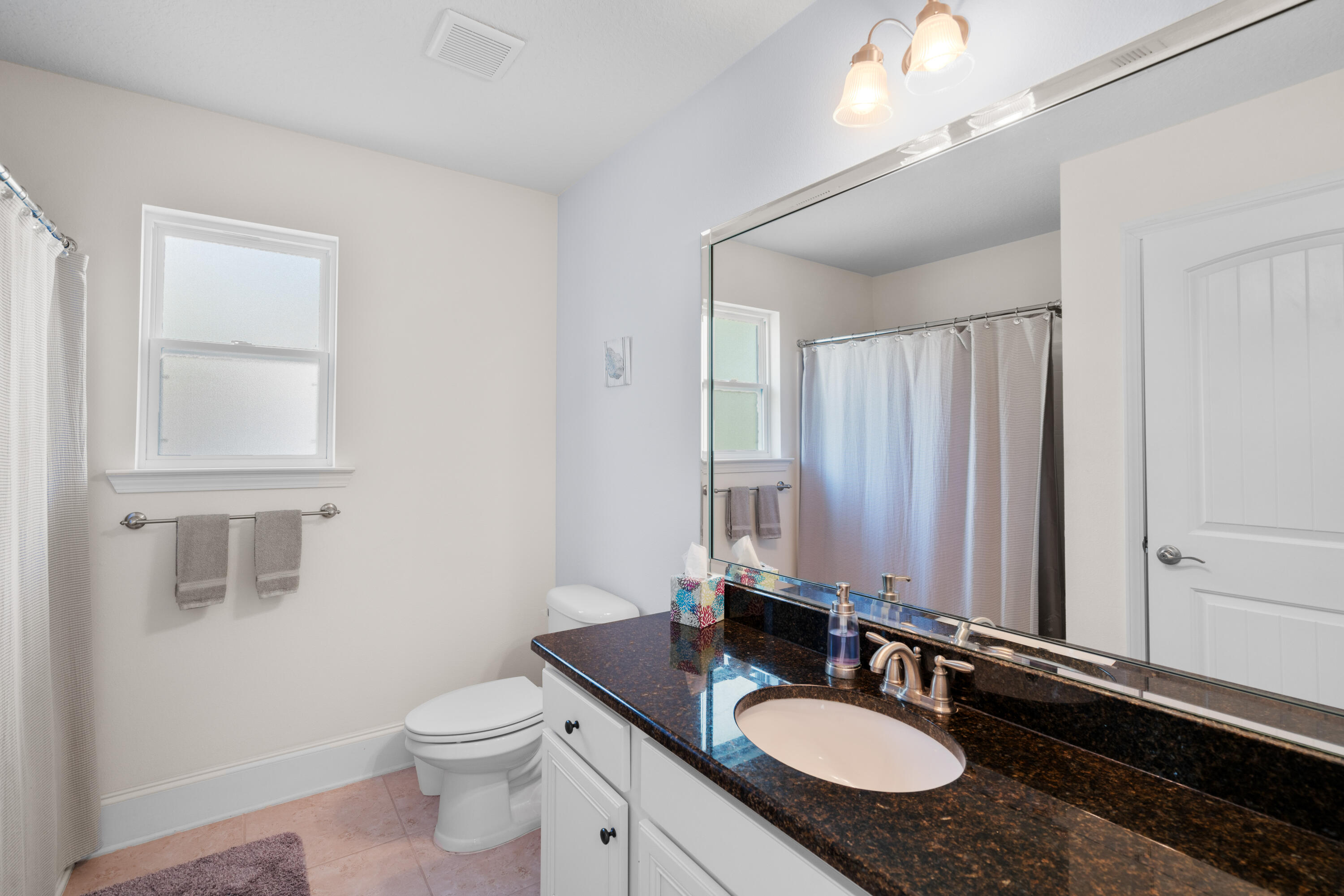 173 Grayling Way Inlet Beach, FL 32461 - Photo 27 of 47 a bathroom with a granite countertop sink a toilet a mirror and vanity